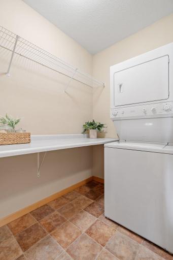 In-unit laundry with additional storage space.