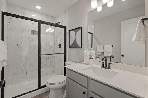 Owners Suite Bathroom has floor to ceiling tiled shower walls.