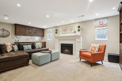 Roomy lower level family room with wet bar, gas fireplace, and built in entertainment center.