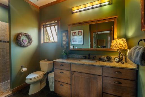 Private primary three-quarter bathroom with charming finishes.