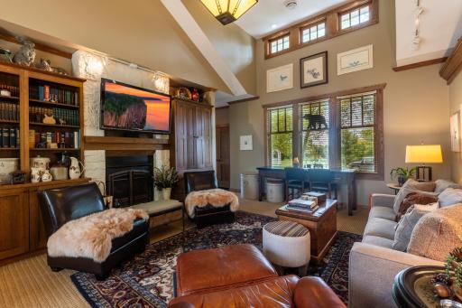 The living room is a sight to behold with its stunning 14-foot vaulted ceiling.