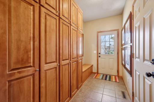 Secondary front entrance leads to your mudroom with bench seating, and incredible wall of storage lockers. Perfect for sporting equipment, coats & accessories