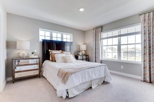 This primary bedroom is a welcome reprieve at the end of a long day, and a great place to begin the next day! Model home, details will vary.