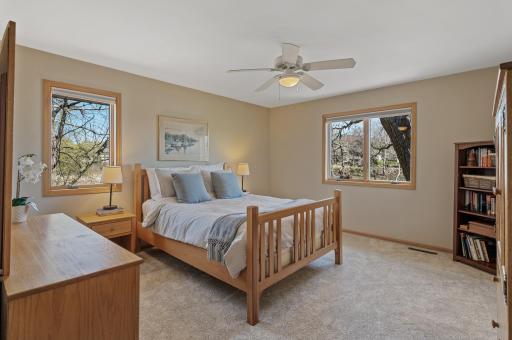 Large primary bedroom with views overlooking the pond. Open the windows and wake up to the sounds of nature.