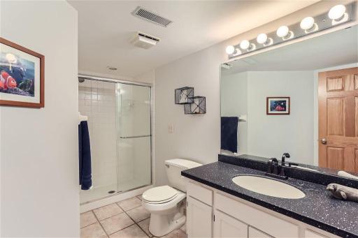 The lower level bathroom features an additional shower for the lower level bedroom. This countertop and faucet was also recently updated.