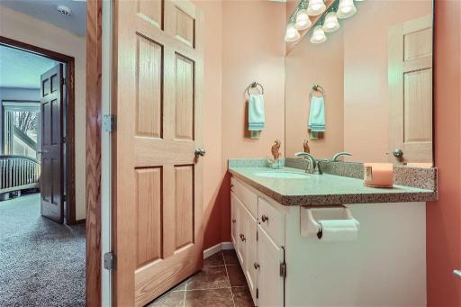 The upper level shared bathroom is pristine and ideal for easy access from the bedrooms. Updated countertop an faucet here as well.