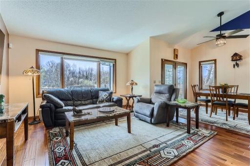 Enjoy the living room that has an open feel and plenty of natural light. To the right is the dining room and 3-season porch. You will love the views of the nature area outside.