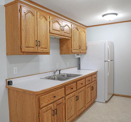 The wet bar just off the rec room has a new fridge and another closet just across. Easily divided living spaces are a real possibility here..jpg