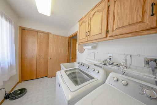 The main floor laundry room also accomodates more closet space! Newer appliances, electric dryer and natural light so you can see All the stains!.jpg