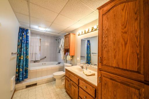 The large lower level bath includes its' own linen closet. Storage has been built into this home in every possible room!.jpg