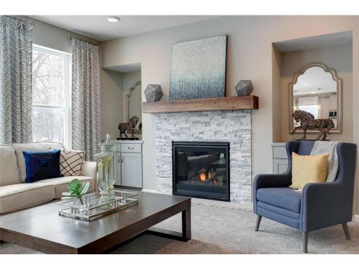 The family room is enhanced by a gas fireplace - creating both warmth and a focal point to the room.photo of model home, color and options will vary.