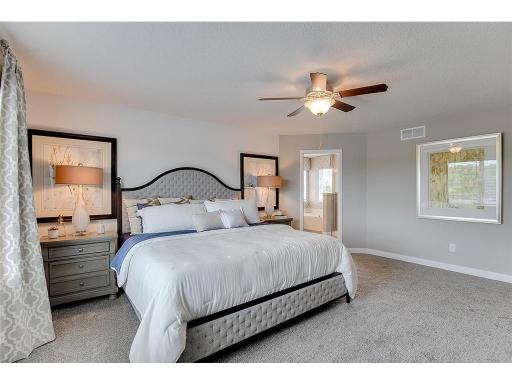 An oasis of its own, the primary suite offers the perfect escape. Windows will overlook the backyard, and there's immediate access to a private bathroom that features a TWO walk-in closets!! Photo of model home, color and options will vary.