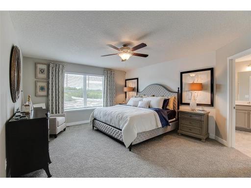 An oasis of its own, the primary suite offers the perfect escape. Windows will overlook the backyard, and there's immediate access to a private bathroom that features TWO walk-in closets!! Photo of model home, color and options will vary.