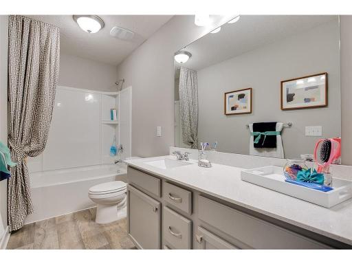 Convenience for the kids too, as the home's upper level guest bathroom features an extra long vanity and linen cabinet. Photo of model home, color and options will vary.