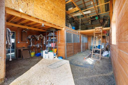 Tack Room on left with 2 box horse stalls, hayloft/storage area