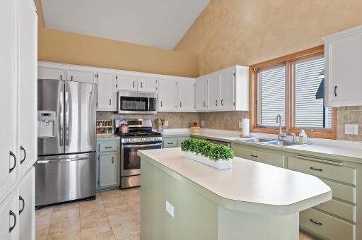 Fresh and bright kitchen with vaulted ceiling & stainless steel appliances