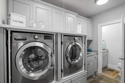 Main floor laundry with half bathroom. Granite counter tops throughout. Laundry sink area as well.