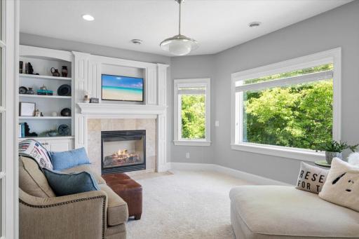 Enter through the French doors to the den space. Relax by the fire and look out to the lake. Built ins around the fireplace provide a great space to add decor.