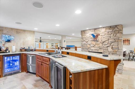 The ultimate bar space with beverage fridge, wine fridge, dishwasher, fridge, and icemaker.