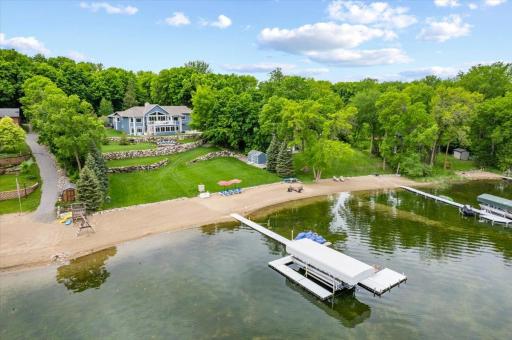 Welcome to Cedar Lake. This luxurious lake home sits on 1.23 acres, with 146 feet of sandy lakeshore. New 10 by 20-foot storage shed added in 2023. Multiple firepits with firewood storage. Expansive rock wall and beautiful landscaping throughout.