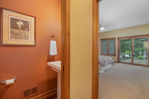 The 1/2 bathroom features: a 9 foot knock down ceiling with an exhaust fan, a pedestal Kohler sink, Kohler toilet, and Brazilian cherry hardwood floors.