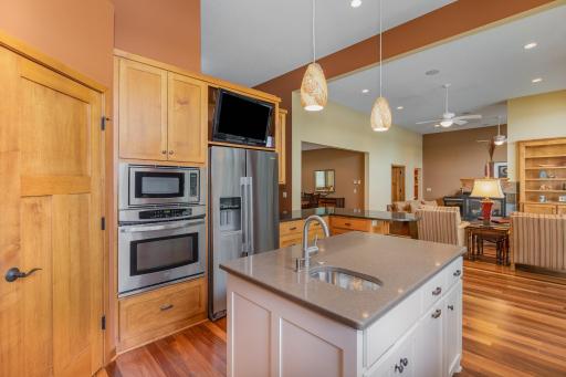 The kitchen also features stainless steel appliances, including: a side by side Whirlpool refrigerator (new in 2019); and built-in Kenmore microwave & wall oven.