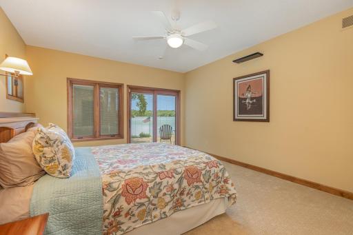 The primary bedroom offers spectacular views of the lake through: the 2 west-facing windows; and the sliding glass door - which provides convenient access to the paver patio & hot tub. The hot tub (new in 2020) stays with the home!