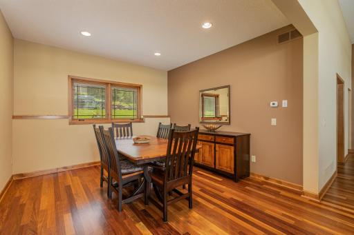 Another view of the formal dining room. This space features: gorgeous Brazilian cherry hardwood floors, 2 east-facing windows, and a 9 ft knock down ceiling w/4 recessed lights. The custom table, 6 chairs, buffet & mirror are available for purchase.