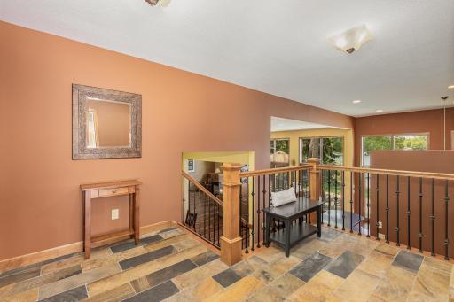 Your guests will be warmly greeted by this open foyer. It has beautiful slate tile floors and provides immediate views of the lake.