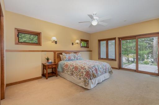 This primary bedroom suite offers plenty of room for a king size bed & several dressers. It features: a 9 ft knock down ceiling with ceiling fan; and 2 south & 2 west facing windows. The queen size bed and nightstand are available for purchase.