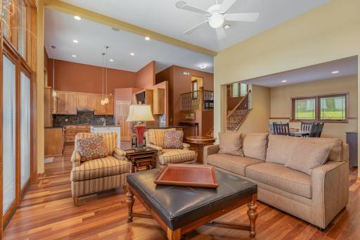 Another view of the living room, dining room, foyer and kitchen. The sofa, 2 chairs, 2 bench seats, ottoman w/tray, 3 nesting tables, end table, and 2 lamps are available for purchase.