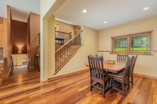 Down a half flight of stairs from the foyer, is the formal dining room. On the left side of the photo, you can see the drawers from one of the kitchen islands, and the hallway leading to the lower level family room.
