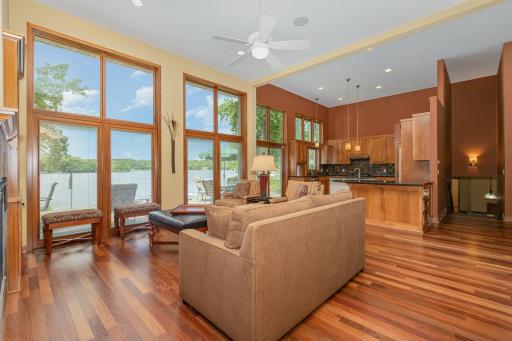 Check out the stunning views from this living room - overlooking the patio, lake and open kitchen.