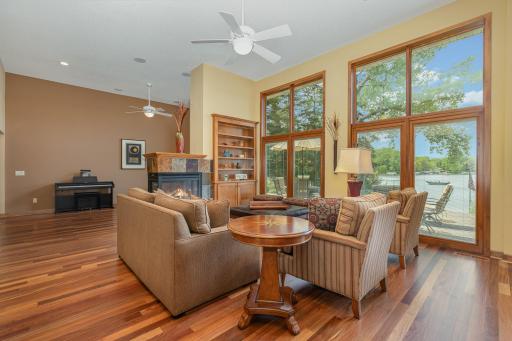 The living room features: a 12 foot, knock down ceiling with 4 recessed lights, a ceiling fan, and 1 built-in speaker (next to the kitchen speaker); and Brazilian cherry hardwood floors.