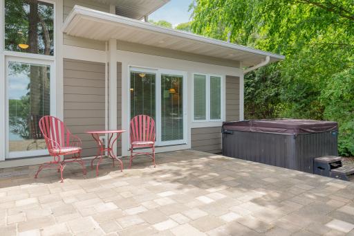 The far south wing of this residence houses the private, primary bedroom suite. And provides convenient access to the paver patio and hot tub!
