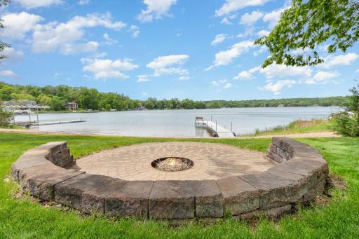 A close up of the custom, paver fire pit area - looking west towards the lake and the private dock. This home provides the most AMAZING year round sunset views!
