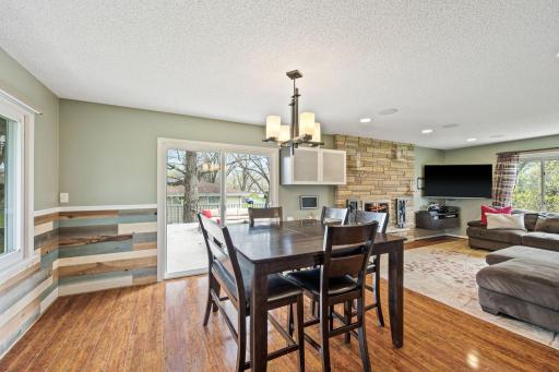 Main floor dining room offers a wood feature wall and easy to clean laminate floors. Convenient access to oversized patio to enjoy grilling and hosting large gatherings.