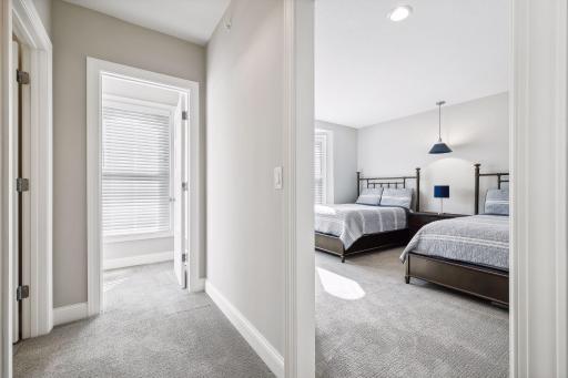 A sun-filled second Junior Bedroom Suite is located on the upper level and offers a walk-in closet with custom organizer system.