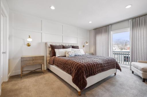 The upper floor houses the tranquil Primary Suite which offers a board and batten feature wall and a walk-in closet with custom organizer system. The sliding glass door leads to your private deck.