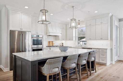 The Kitchen features custom cabinetry with soft-close door and drawers, beautiful quartz countertops and professional stainless steel appliances from KitchenAid.