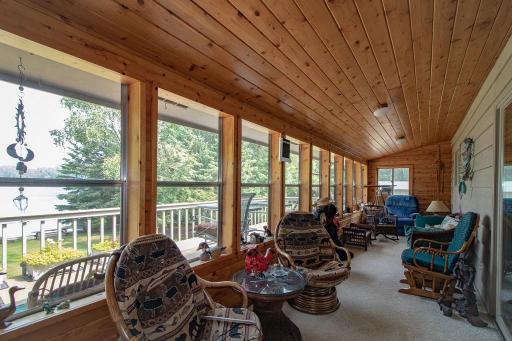 3 season lakeside porch with a world of windows overlooking the lake! What a exceptionally great spot to enjoy the lake with friends or family!