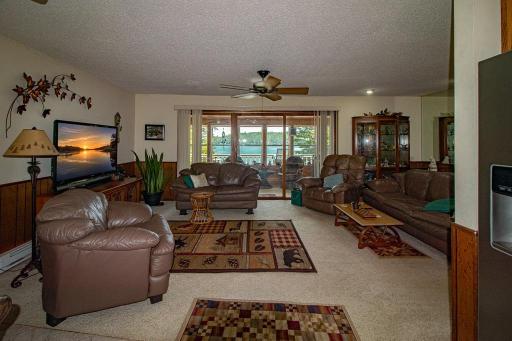 Comfortable Living Room with patio door leading to lakeside 3 season porch. GREAT lake views!