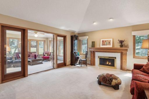 Living room with gas fireplace and vaulted ceiling.