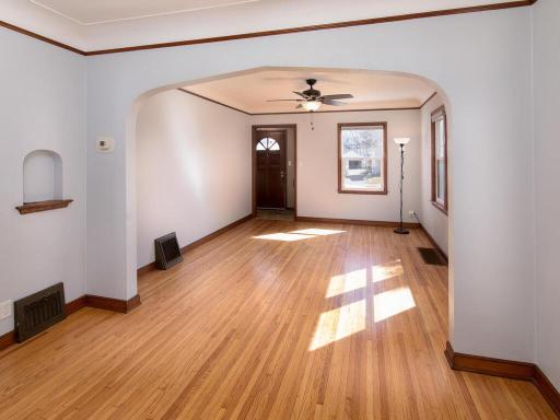 Coved ceilings, arched doorways, and wide baseboards highlight the main living areas.