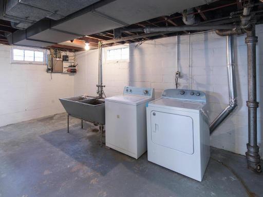 Laundry area with large utility sink, washer, and dryer.