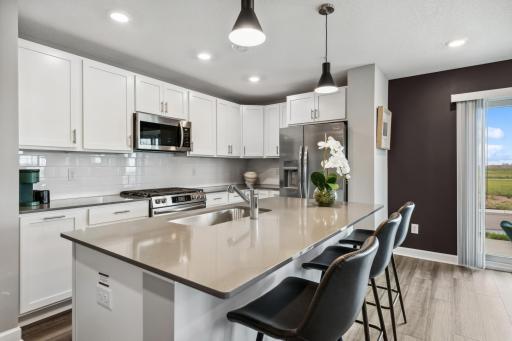 (Photo of decorated model, actual home's finishes vary) Thoughtfully-designed with a combination of functionality and modern design, this kitchen space is sure to impress.