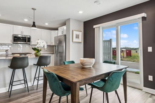 (Photo of decorated model, actual home's finishes vary) Soaked in natural sunlight, the homes eat-in dining room has ample space for a dining table located in the heart of the home.