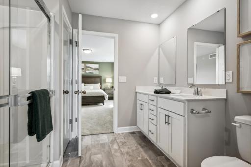 (Photo of decorated model, actual home's finishes vary) An extension of the owner's suite, this private and spacious bath contains a double-vanity, a linen closet and a shower.