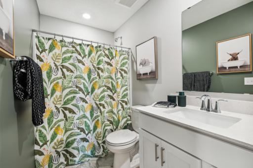 (Photo of decorated model, actual home's finishes vary) The upper level secondary bath is sure to provide plenty of space for everyone to get ready in the morning.