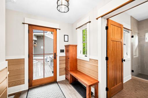 Main Level: Mudroom-Crafted cherry cabinet, large closet with shelves in middle, Pickle wood paneling from Entry Foyer, tile flooring